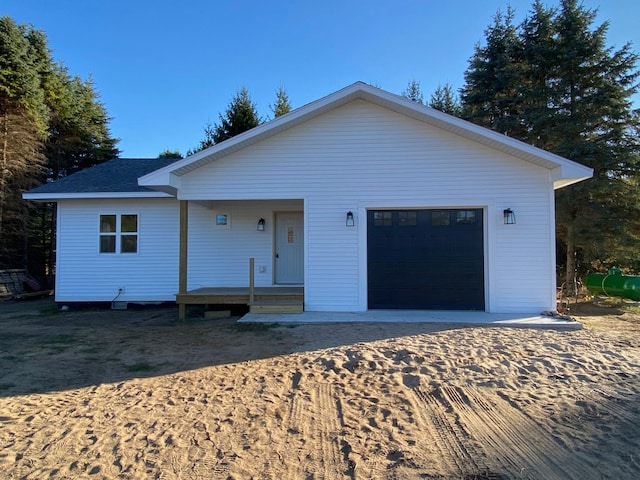 view of front of property featuring a porch and a garage