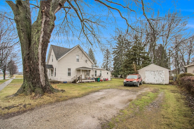35930 Washington St, Richmond, MI 48062 - view of side of property with driveway, a lawn, an outdoor structure, crawl space, and a detached garage