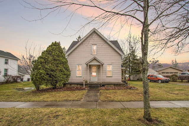 bungalow-style home with a yard