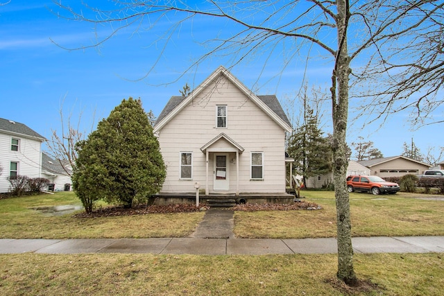 bungalow-style home with a front yard