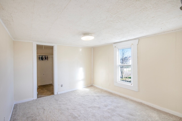 unfurnished room featuring carpet floors and a textured ceiling