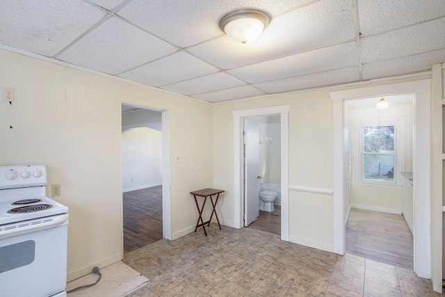 kitchen with white range with electric cooktop, a drop ceiling, and light wood-type flooring