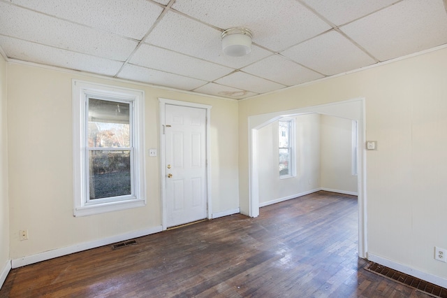 entryway featuring dark hardwood / wood-style flooring, a drop ceiling, and plenty of natural light