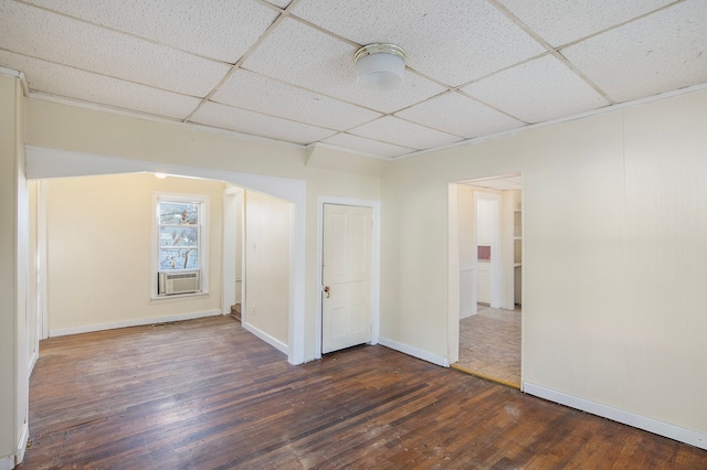 unfurnished room featuring a drop ceiling, cooling unit, and dark hardwood / wood-style floors