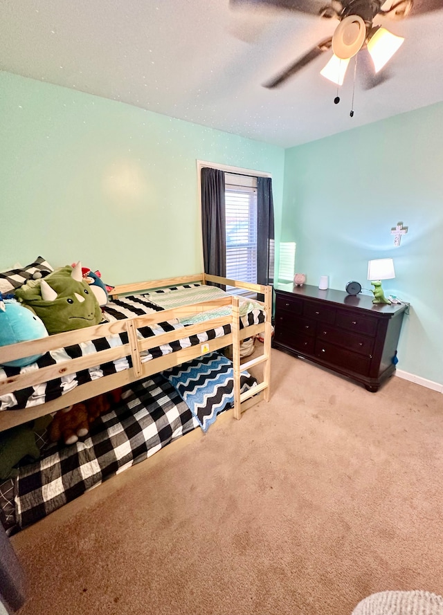 bedroom featuring light colored carpet and ceiling fan