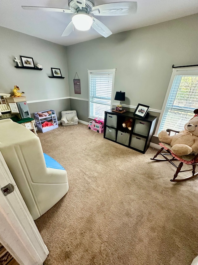 interior space featuring carpet, ceiling fan, and a healthy amount of sunlight