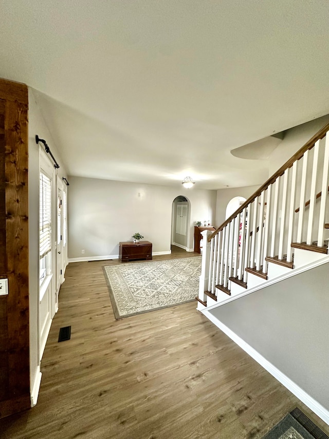 foyer featuring hardwood / wood-style floors and a barn door