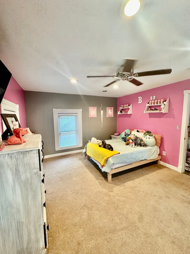 carpeted bedroom featuring ceiling fan and a textured ceiling