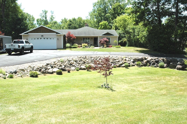 view of front of house with a garage and a front lawn