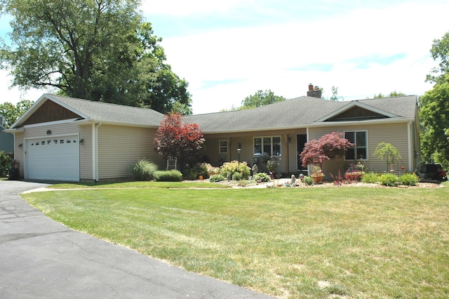 ranch-style house featuring a front yard and a garage