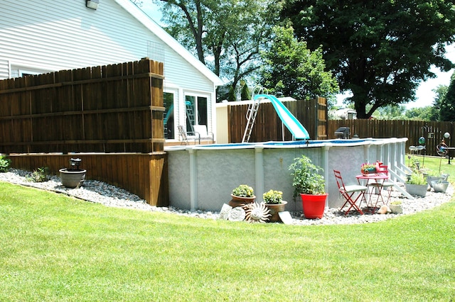 exterior space with a yard and a water slide