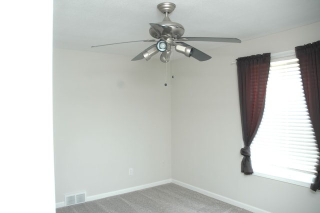 empty room with light colored carpet and ceiling fan