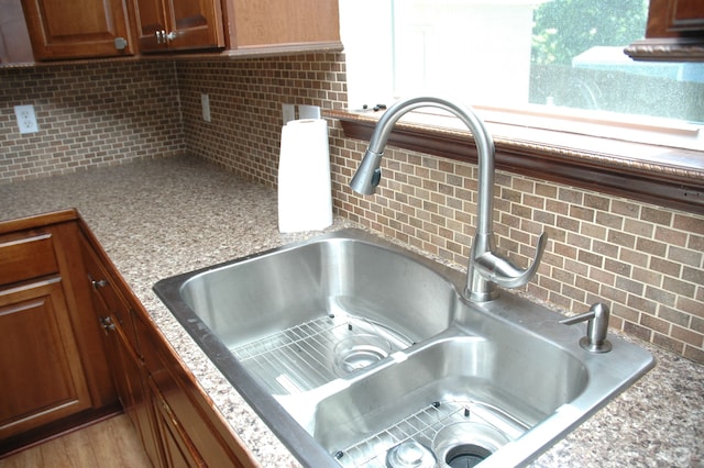 room details featuring decorative backsplash and sink