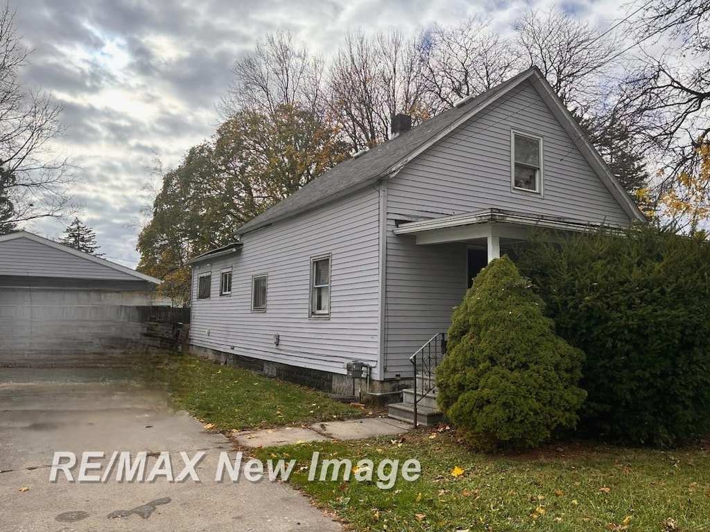 view of side of property with an outbuilding and a garage