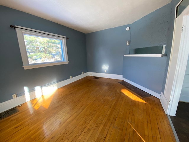 spare room featuring hardwood / wood-style floors