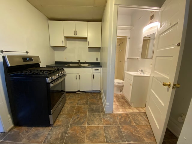 kitchen with white cabinets, sink, and stainless steel gas range