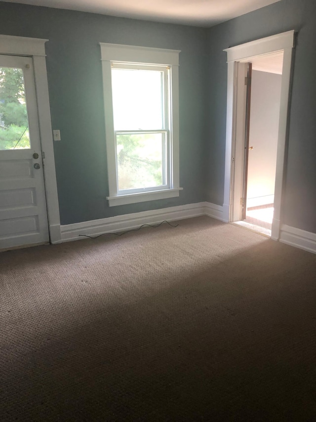 unfurnished room with carpet and a healthy amount of sunlight