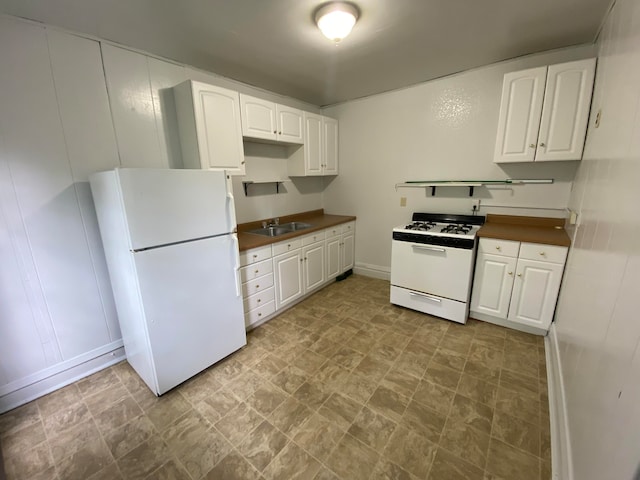 kitchen featuring white cabinets, white appliances, and sink