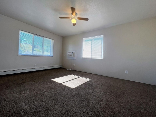 carpeted empty room featuring a wall mounted AC, a baseboard heating unit, ceiling fan, and a healthy amount of sunlight