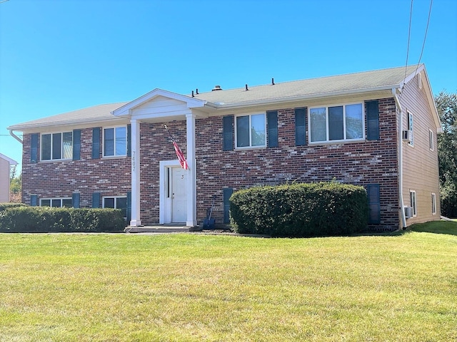 bi-level home with a front lawn