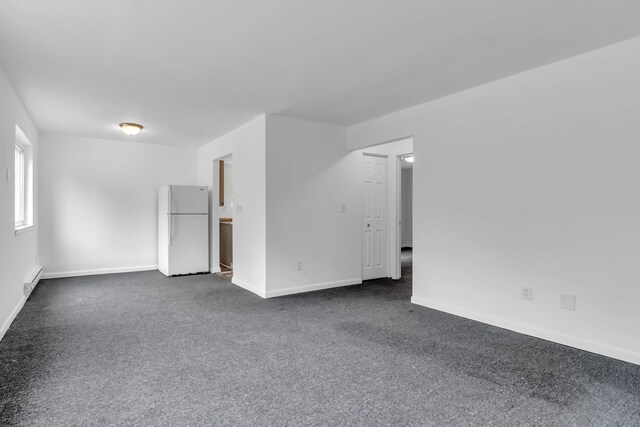 10420 Whittier St, Detroit, MI 48224 - spare room with dark colored carpet and baseboards