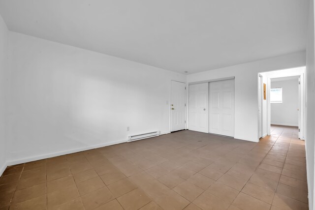 10420 Whittier St, Detroit, MI 48224 - unfurnished bedroom with baseboard heating, baseboards, and a closet