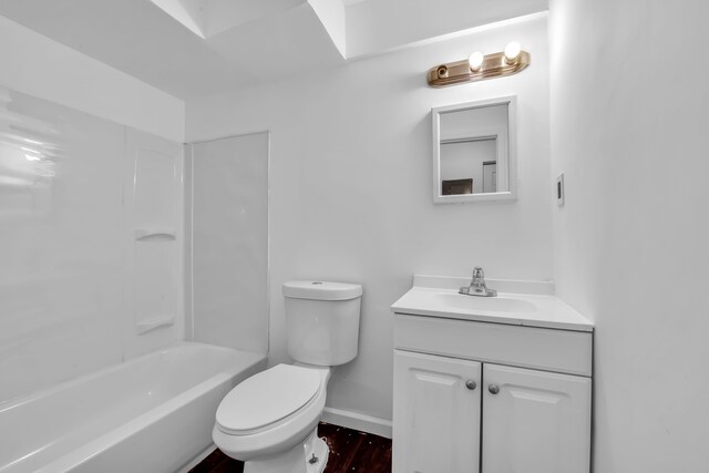 10420 Whittier St, Detroit, MI 48224 - bathroom featuring vanity, toilet, baseboards,  shower combination, and wood finished floors