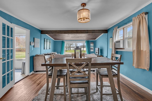 dining area with beam ceiling, crown molding, and wood-type flooring