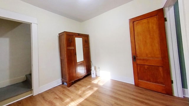 unfurnished bedroom with light wood-type flooring