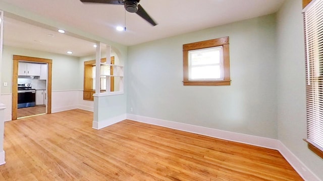 unfurnished room with ceiling fan and light hardwood / wood-style floors