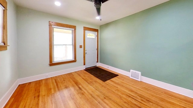 foyer entrance featuring ceiling fan and wood-type flooring