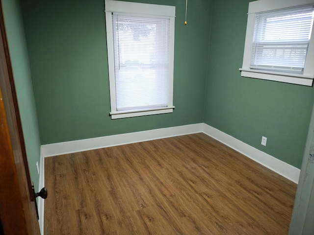 empty room with hardwood / wood-style floors