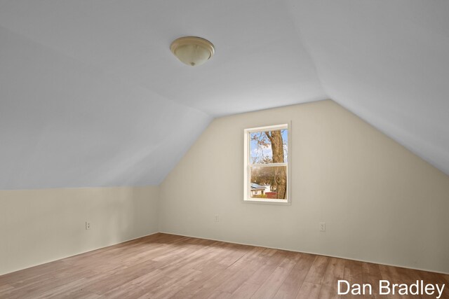 bonus room featuring hardwood / wood-style floors and vaulted ceiling