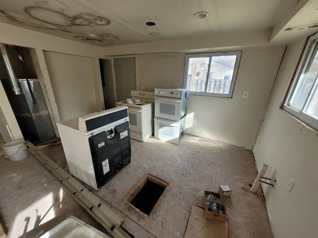 kitchen featuring white range with electric stovetop and white cabinets