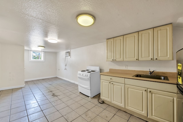 kitchen featuring light tile patterned floors, a textured ceiling, white range with electric cooktop, and sink