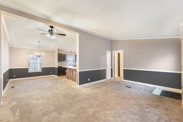 unfurnished living room featuring light carpet, a textured ceiling, ceiling fan with notable chandelier, and crown molding