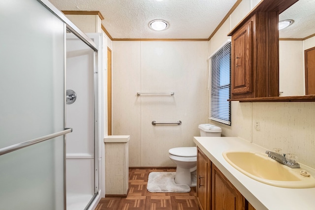 bathroom with vanity, a shower with door, parquet floors, ornamental molding, and a textured ceiling