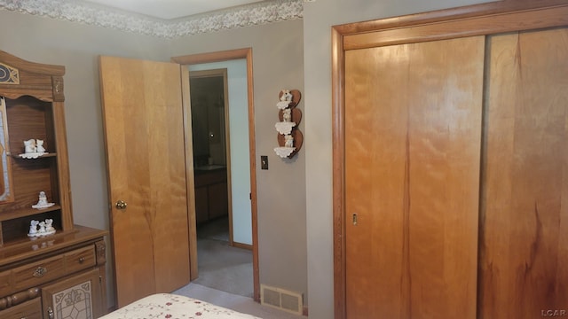 carpeted bedroom featuring a closet