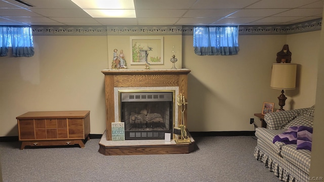 living room featuring carpet flooring and a paneled ceiling