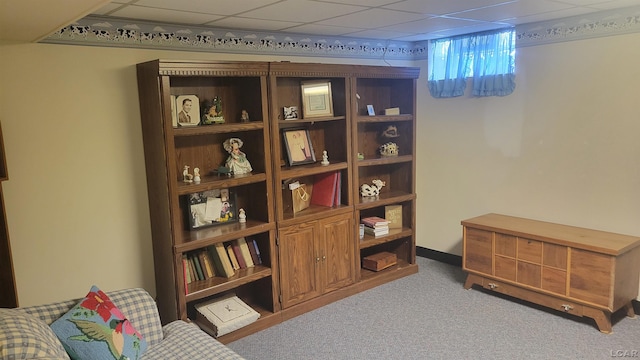 living area with carpet flooring and a drop ceiling