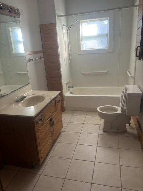 full bathroom with shower / bathing tub combination, tile patterned flooring, toilet, and vanity