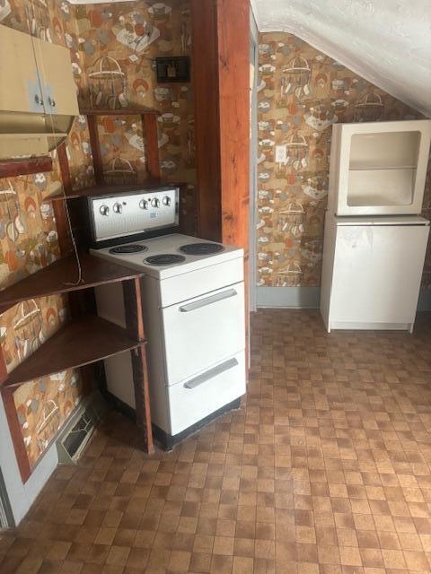 231 W Todd Ave, Reed City, MI 49677 - kitchen featuring electric stove and lofted ceiling