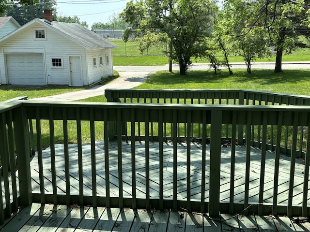 231 W Todd Ave, Reed City, MI 49677 - deck featuring an outdoor structure, a garage, and a lawn