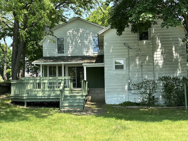 231 W Todd Ave, Reed City, MI 49677 - rear view of property featuring a lawn and a wooden deck
