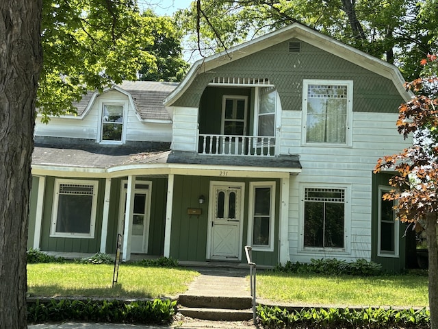 231 W Todd Ave, Reed City, MI 49677 - view of front of home with a front yard, board and batten siding, a shingled roof, and a porch