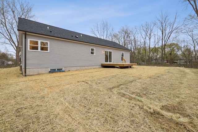 rear view of house featuring a yard and a wooden deck