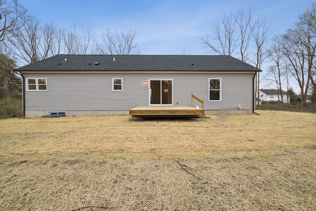 rear view of house with a lawn and a wooden deck