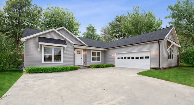 view of front of property with a garage and a front lawn