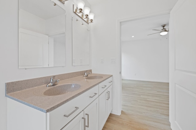 bathroom featuring ceiling fan, wood-type flooring, and vanity