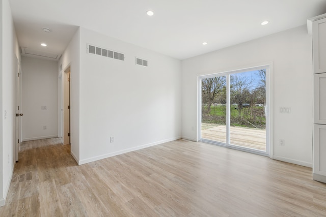 spare room featuring light hardwood / wood-style flooring